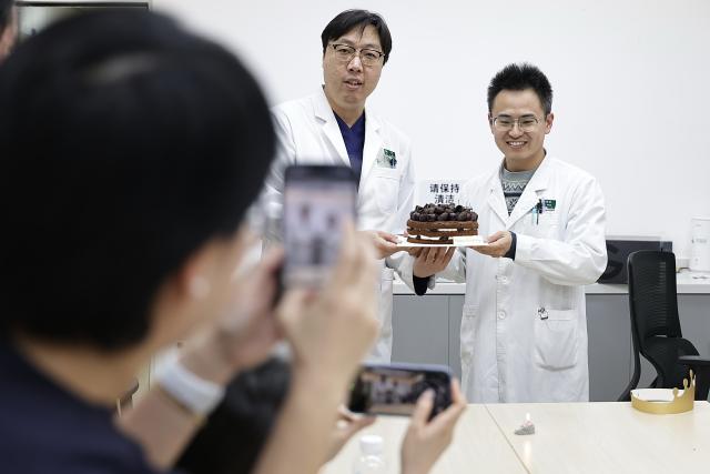 (260214) -- BEIJING, Feb. 14, 2026 (Xinhua) -- At 7:04 p.m. on Feb. 5, 2026: two doctors celebrate their birthday with colleagues at an on-call room of the Emergency Department in Guang'anmen Hospital in Beijing, capital of China. With the Spring Festival just around the corner, the staff members at the Emergency Department of Guang'anmen Hospital remain on duty around the clock. Racing against time, they are fully committed to protect the health of patients.
   As a national-level emergency center which integrates Traditional Chinese Medicine and Western medicine, the Emergency Department of Guang'anmen Hospital was founded over 40 years ago. Generations of medical practitioners have carried forward the wisdom of Traditional Chinese Medicine while keeping pace with modern emergency rescue. They are not only proficient in using advanced emergency equipment such as Extracorporeal Membrane Oxygenation (ECMO) and ultrasound diagnostic instruments to rescue critically ill patients, but also provide patients with precise and effective characteristic diagnosis and treatment, featuring over 30 hospital-agreed prescriptions and more than 20 external treatment methods of Traditional Chinese Medicine. (Xinhua/Zhang Yuwei)