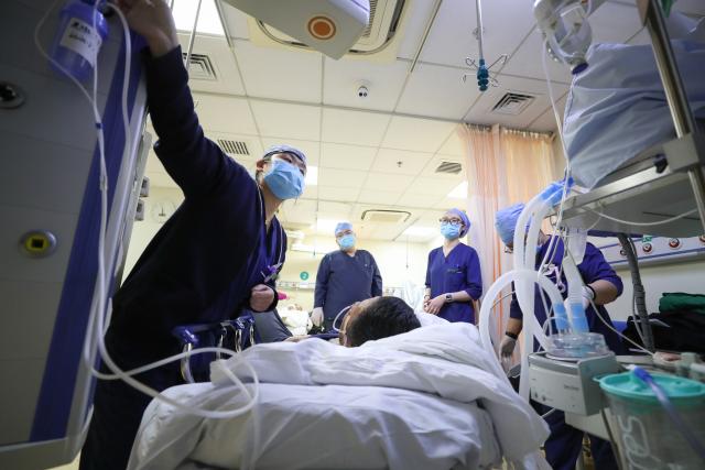 (260214) -- BEIJING, Feb. 14, 2026 (Xinhua) -- At 5:59 p.m. on Feb. 5, 2026: nurses hand over the shift in a resuscitation room of the Emergency Department in Guang'anmen Hospital in Beijing, capital of China. With the Spring Festival just around the corner, the staff members at the Emergency Department of Guang'anmen Hospital remain on duty around the clock. Racing against time, they are fully committed to protect the health of patients.
   As a national-level emergency center which integrates Traditional Chinese Medicine and Western medicine, the Emergency Department of Guang'anmen Hospital was founded over 40 years ago. Generations of medical practitioners have carried forward the wisdom of Traditional Chinese Medicine while keeping pace with modern emergency rescue. They are not only proficient in using advanced emergency equipment such as Extracorporeal Membrane Oxygenation (ECMO) and ultrasound diagnostic instruments to rescue critically ill patients, but also provide patients with precise and effective characteristic diagnosis and treatment, featuring over 30 hospital-agreed prescriptions and more than 20 external treatment methods of Traditional Chinese Medicine. (Xinhua/Wang Jingqiang)