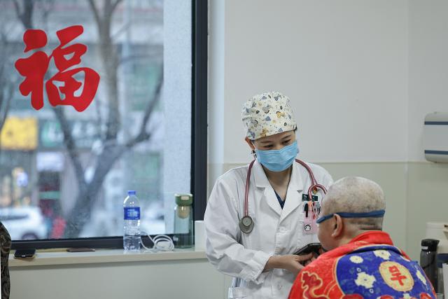 (260214) -- BEIJING, Feb. 14, 2026 (Xinhua) -- At 7:42 a.m. on Feb. 9, 2026: doctor Li Qiong treats a patient in the Emergency Department in Guang'anmen Hospital in Beijing, capital of China. With the Spring Festival just around the corner, the staff members at the Emergency Department of Guang'anmen Hospital remain on duty around the clock. Racing against time, they are fully committed to protect the health of patients.
   As a national-level emergency center which integrates Traditional Chinese Medicine and Western medicine, the Emergency Department of Guang'anmen Hospital was founded over 40 years ago. Generations of medical practitioners have carried forward the wisdom of Traditional Chinese Medicine while keeping pace with modern emergency rescue. They are not only proficient in using advanced emergency equipment such as Extracorporeal Membrane Oxygenation (ECMO) and ultrasound diagnostic instruments to rescue critically ill patients, but also provide patients with precise and effective characteristic diagnosis and treatment, featuring over 30 hospital-agreed prescriptions and more than 20 external treatment methods of Traditional Chinese Medicine. (Xinhua/Zhang Yuwei)