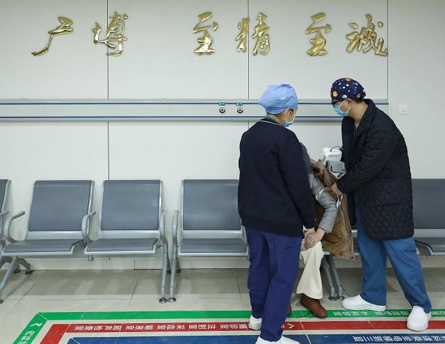(260214) -- BEIJING, Feb. 14, 2026 (Xinhua) -- At 9:37 p.m. on Feb. 5, 2026: nurses measure the blood pressure of a patient at the emergency hall in Guang'anmen Hospital in Beijing, capital of China. With the Spring Festival just around the corner, the staff members at the Emergency Department of Guang'anmen Hospital remain on duty around the clock. Racing against time, they are fully committed to protect the health of patients.
   As a national-level emergency center which integrates Traditional Chinese Medicine and Western medicine, the Emergency Department of Guang'anmen Hospital was founded over 40 years ago. Generations of medical practitioners have carried forward the wisdom of Traditional Chinese Medicine while keeping pace with modern emergency rescue. They are not only proficient in using advanced emergency equipment such as Extracorporeal Membrane Oxygenation (ECMO) and ultrasound diagnostic instruments to rescue critically ill patients, but also provide patients with precise and effective characteristic diagnosis and treatment, featuring over 30 hospital-agreed prescriptions and more than 20 external treatment methods of Traditional Chinese Medicine. (Xinhua/Zhang Yuwei)