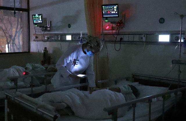 (260214) -- BEIJING, Feb. 14, 2026 (Xinhua) -- At 11:39 p.m. on Feb. 3, 2026: a nurse patrols a ward and checks the condition of patients in the Emergency Department of Guang'anmen Hospital in Beijing, capital of China. With the Spring Festival just around the corner, the staff members at the Emergency Department of Guang'anmen Hospital remain on duty around the clock. Racing against time, they are fully committed to protect the health of patients.
   As a national-level emergency center which integrates Traditional Chinese Medicine and Western medicine, the Emergency Department of Guang'anmen Hospital was founded over 40 years ago. Generations of medical practitioners have carried forward the wisdom of Traditional Chinese Medicine while keeping pace with modern emergency rescue. They are not only proficient in using advanced emergency equipment such as Extracorporeal Membrane Oxygenation (ECMO) and ultrasound diagnostic instruments to rescue critically ill patients, but also provide patients with precise and effective characteristic diagnosis and treatment, featuring over 30 hospital-agreed prescriptions and more than 20 external treatment methods of Traditional Chinese Medicine. (Xinhua/Zhang Yuwei)
