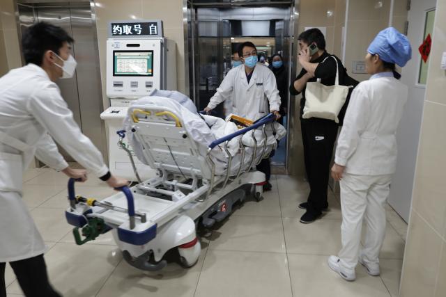 (260214) -- BEIJING, Feb. 14, 2026 (Xinhua) -- At 1:46 p.m. on Feb. 12, 2026: staff members transfer a patient from an observation room to the intensive care unit (ICU) in the Emergency Department of Guang'anmen Hospital in Beijing, capital of China. With the Spring Festival just around the corner, the staff members at the Emergency Department of Guang'anmen Hospital remain on duty around the clock. Racing against time, they are fully committed to protect the health of patients.
   As a national-level emergency center which integrates Traditional Chinese Medicine and Western medicine, the Emergency Department of Guang'anmen Hospital was founded over 40 years ago. Generations of medical practitioners have carried forward the wisdom of Traditional Chinese Medicine while keeping pace with modern emergency rescue. They are not only proficient in using advanced emergency equipment such as Extracorporeal Membrane Oxygenation (ECMO) and ultrasound diagnostic instruments to rescue critically ill patients, but also provide patients with precise and effective characteristic diagnosis and treatment, featuring over 30 hospital-agreed prescriptions and more than 20 external treatment methods of Traditional Chinese Medicine. (Xinhua/Zhang Yuwei)