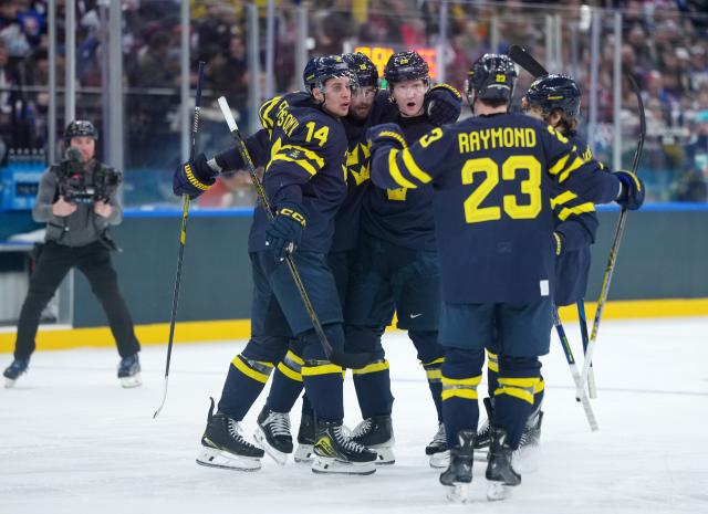 (260214) -- MILAN, Feb. 14, 2026 (Xinhua) -- Adrian Kempe (2nd L) of Sweden celebrates his score with his teammates during the ice hockey men's preliminary round group B match between Sweden and Slovakia of the Milan-Cortina 2026 Olympic Winter Games in Milan, Italy, Feb. 14, 2026. (Xinhua/Tao Xiyi)