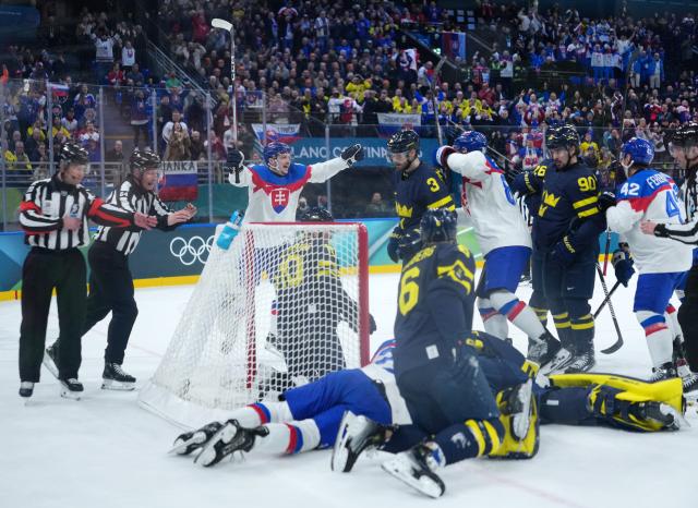 (260214) -- MILAN, Feb. 14, 2026 (Xinhua) -- Players of Slovakia celebrate for a goal, which is later disallowed during the ice hockey men's preliminary round group B match between Sweden and Slovakia of the Milan-Cortina 2026 Olympic Winter Games in Milan, Italy, Feb. 14, 2026. (Xinhua/Tao Xiyi)