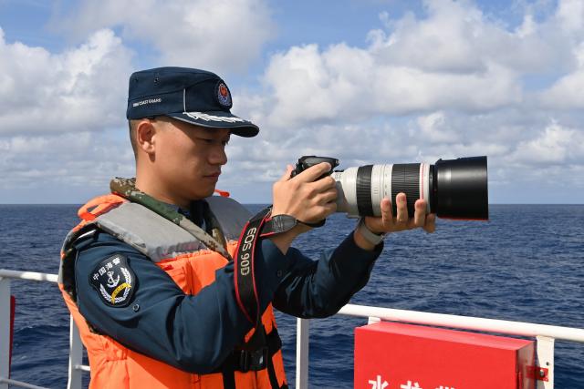 (260214) -- SOUTH CHINA SEA, Feb. 14, 2026 (Xinhua) -- Law enforcer Qiu Canhui conducts evidence collection training aboard the China Coast Guard (CCG) vessel Wanshan in the territorial waters of China's Huangyan Dao, Feb. 11, 2026. Right ahead of the Chinese New Year, a traditional occasion for family reunion in China, a group of young law enforcers remain loyally stationed and highly alert around the clock, hundreds of miles away from their loved ones. (Photo by Zhai Yifan/Xinhua)