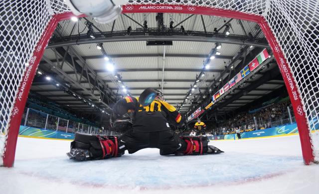 (260214) -- MILAN, Feb. 14, 2026 (Xinhua) -- Philipp Grubauer, goalkeeper of Germany fails to make a save during the ice hockey men's preliminary round group C match between Germany and Latvia of the Milan-Cortina 2026 Olympic Winter Games in Milan, Italy, Feb. 14, 2026. (Sun Fei/Pool via Xinhua)