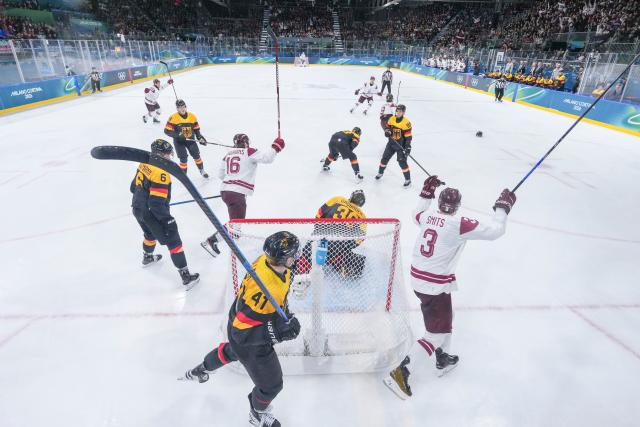 (260214) -- MILAN, Feb. 14, 2026 (Xinhua) -- Players of Latvia celebrate a goal during the ice hockey men's preliminary round group C match between Germany and Latvia of the Milan-Cortina 2026 Olympic Winter Games in Milan, Italy, Feb. 14, 2026. (Xinhua/Sun Fei)