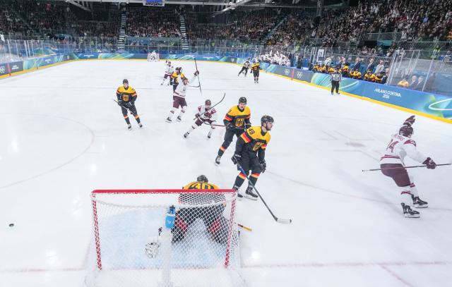 (260214) -- MILAN, Feb. 14, 2026 (Xinhua) -- Eduards Tralmaks (1st R) of Latvia celebrates his goal during the ice hockey men's preliminary round group C match between Germany and Latvia of the Milan-Cortina 2026 Olympic Winter Games in Milan, Italy, Feb. 14, 2026. (Xinhua/Sun Fei)