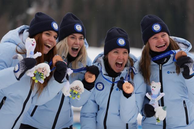 (260214) -- TESERO, Feb. 14, 2026 (Xinhua) -- Johanna Matintalo, Kerttu Niskanen, Vilma Ryytty and Jasmi Joensuu of Finland pose for photos during the awarding ceremony of the cross-country skiing women's 4x7.5km relay match at the Milan-Cortina 2026 Olympic Winter Games in Tesero, Italy, Feb. 14, 2026. (Xinhua/Peng Ziyang)