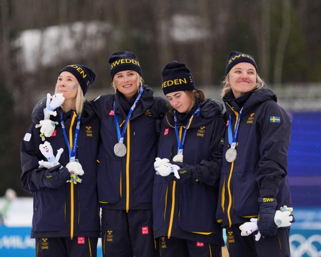 (260214) -- TESERO, Feb. 14, 2026 (Xinhua) -- Linn Svahn, Ebba Andersson, Frida Karlsson and Jonna Sundling of Sweden attend the awarding ceremony of the cross-country skiing women's 4x7.5km relay match at the Milan-Cortina 2026 Olympic Winter Games in Tesero, Italy, Feb. 14, 2026. (Xinhua/Peng Ziyang)