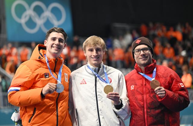 (260214) -- MILAN, Feb. 14, 2026 (Xinhua) -- Gold medalist Jordan Stolz (C) of the United States, silver medalist Jenning de Boo (L) of the Netherlands, and bronze medalist Laurent Dubreuil of Canada pose for photos during the awarding ceremony of the speed skating men's 500m final at the Milan-Cortina 2026 Olympic Winter Games in Milan, Italy, Feb. 14, 2026. (Xinhua/Wu Wei)