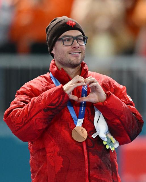 (260214) -- MILAN, Feb. 14, 2026 (Xinhua) -- Bronze medalist Laurent Dubreuil of Canada gestures during the awarding ceremony of the speed skating men's 500m final at the Milan-Cortina 2026 Olympic Winter Games in Milan, Italy, Feb. 14, 2026. (Xinhua/Wu Wei)