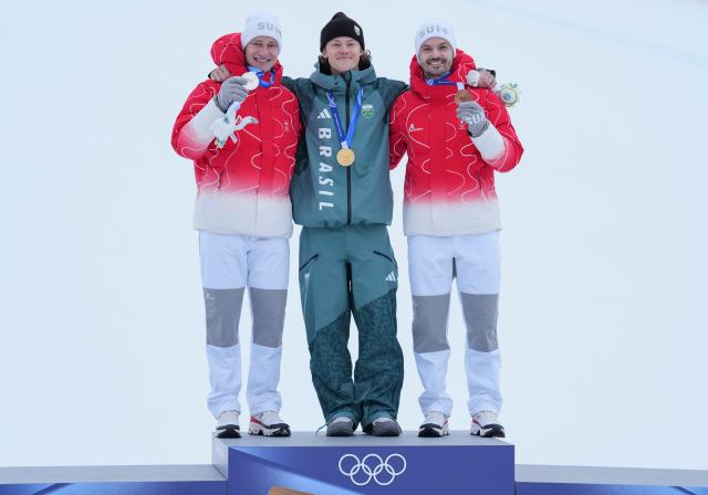 (260214) -- BORMIO, Feb. 14, 2026 (Xinhua) -- Gold medalist Lucas Pinheiro Braathen (C) of Brazil, silver medalist Marco Odermatt (L) of Switzerland, and bronze medalist Loic Meillard of Switzerland pose for photos during the awarding ceremony of the alpine skiing men's giant slalom event at the Milan-Cortina 2026 Olympic Winter Games in Bormio, Italy, Feb. 14, 2026. (Xinhua/Hu Huhu)