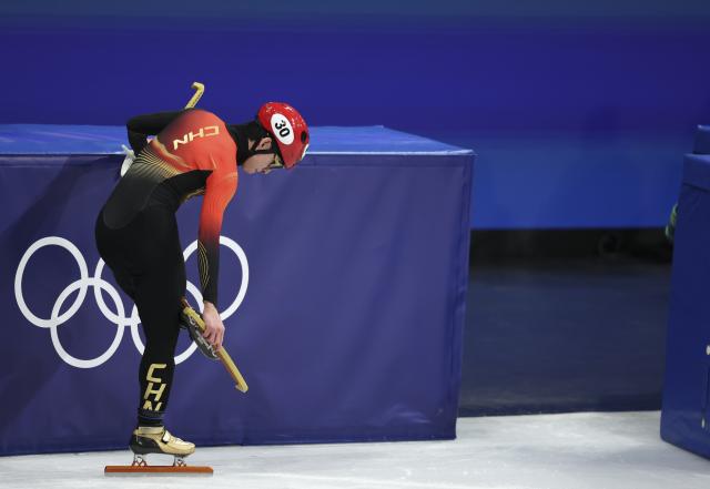 (260214) -- MILAN, Feb. 14, 2026 (Xinhua) -- Lin Xiaojun of China takes off skates after the short track speed skating men's 1500m quarterfinal at the Milan-Cortina 2026 Olympic Winter Games in Milan, Italy, Feb. 14, 2026. (Xinhua/Li Ming)