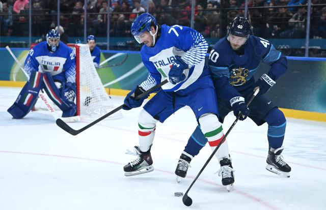 (260214) -- MILAN, Feb. 14, 2026 (Xinhua) -- Gregory di Tomaso (front L) of Italy vies with Joel Armia of Finland during the ice hockey men's preliminary round group B match between Finland and Italy at the Milan-Cortina 2026 Olympic Winter Games in Milan, Italy, Feb. 14, 2026. (Xinhua/Zhang Haofu)