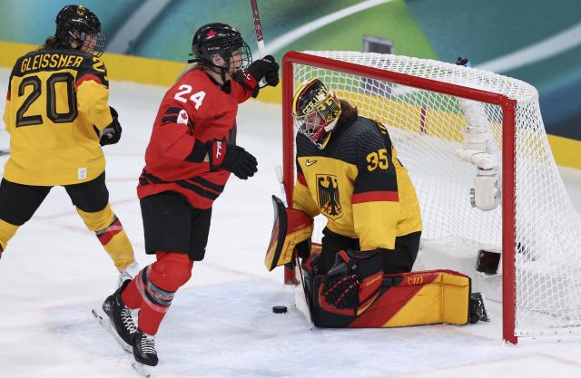 (260214) -- MILAN, Feb. 14, 2026 (Xinhua) -- Goalkeeper Sandra Abstreiter (R) of Germany fails to save the puck during the ice hockey women's play-offs quarterfinal between Canada and Germany at the Milan-Cortina 2026 Olympic Winter Games in Milan, Italy, Feb. 14, 2026. (Xinhua/Wang Kaiyan)