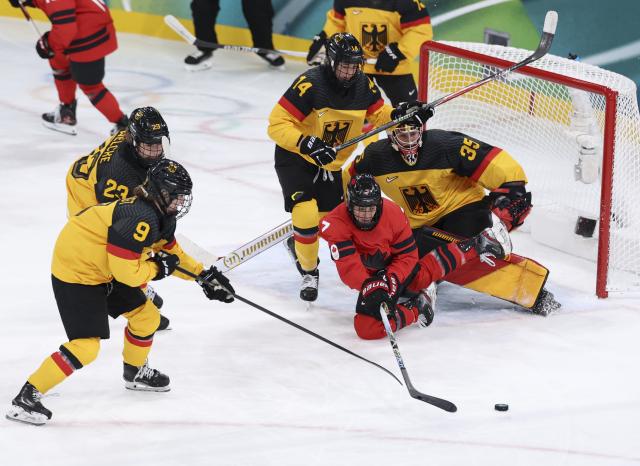 (260214) -- MILAN, Feb. 14, 2026 (Xinhua) -- Laura Stacey (2nd R) of Canada competes with players of Germany during the ice hockey women's play-offs quarterfinal between Canada and Germany at the Milan-Cortina 2026 Olympic Winter Games in Milan, Italy, Feb. 14, 2026. (Xinhua/Wang Kaiyan)