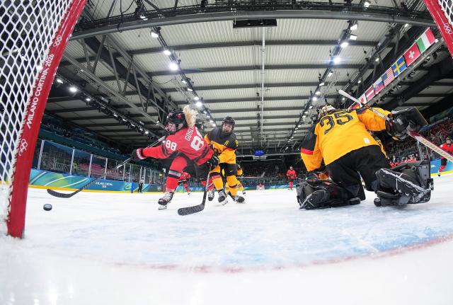 (260214) -- MILAN, Feb. 14, 2026 (Xinhua) -- Julia Gosling (1st L) of Canada shoots during the ice hockey women's play-offs quarterfinal between Canada and Germany at the Milan-Cortina 2026 Olympic Winter Games in Milan, Italy, Feb. 14, 2026. (Xinhua/Sun Fei)