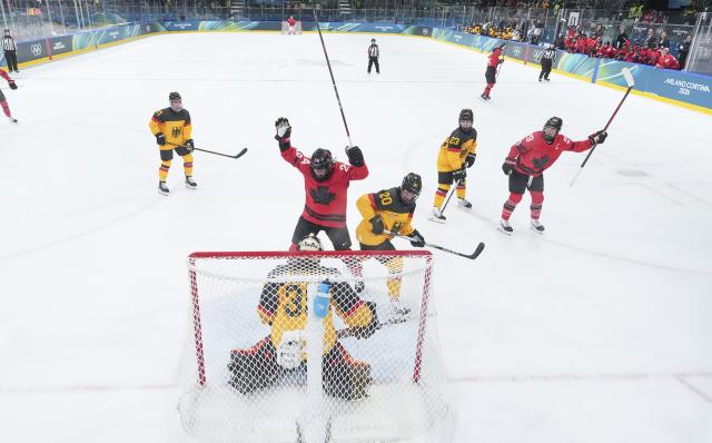 (260214) -- MILAN, Feb. 14, 2026 (Xinhua) -- Goalkeeper Sandra Abstreiter (bottom) of Germany defends during the ice hockey women's play-offs quarterfinal between Canada and Germany at the Milan-Cortina 2026 Olympic Winter Games in Milan, Italy, Feb. 14, 2026. (Xinhua/Sun Fei)