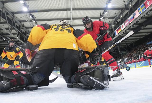 (260214) -- MILAN, Feb. 14, 2026 (Xinhua) -- Goalkeeper Sandra Abstreiter (C) of Germany defends during the ice hockey women's play-offs quarterfinal between Canada and Germany at the Milan-Cortina 2026 Olympic Winter Games in Milan, Italy, Feb. 14, 2026. (Xinhua/Sun Fei)