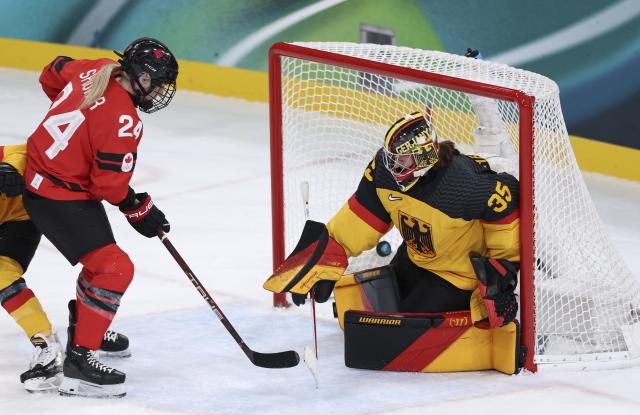 (260214) -- MILAN, Feb. 14, 2026 (Xinhua) -- Goalkeeper Sandra Abstreiter (R) of Germany fails to save the puck during the ice hockey women's play-offs quarterfinal between Canada and Germany at the Milan-Cortina 2026 Olympic Winter Games in Milan, Italy, Feb. 14, 2026. (Xinhua/Wang Kaiyan)