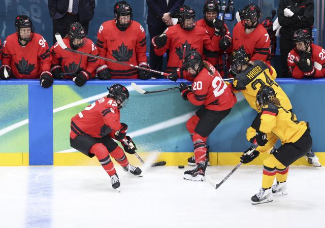 (260214) -- MILAN, Feb. 14, 2026 (Xinhua) -- Claire Thompson (L, front) of Canada competes during the ice hockey women's play-offs quarterfinal between Canada and Germany at the Milan-Cortina 2026 Olympic Winter Games in Milan, Italy, Feb. 14, 2026. (Xinhua/Wang Kaiyan)