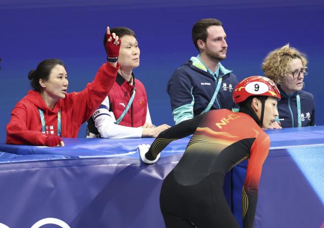 (260214) -- MILAN, Feb. 14, 2026 (Xinhua) -- Sun Long (front) of China waits for the result after the short track speed skating men's 1500m final A at the Milan-Cortina 2026 Olympic Winter Games in Milan, Italy, Feb. 14, 2026. (Xinhua/Li Ming)