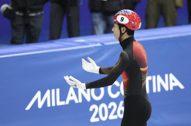 (260214) -- MILAN, Feb. 14, 2026 (Xinhua) -- Sun Long of China reacts after the short track speed skating men's 1500m final A at the Milan-Cortina 2026 Olympic Winter Games in Milan, Italy, Feb. 14, 2026. (Xinhua/Li Ming)