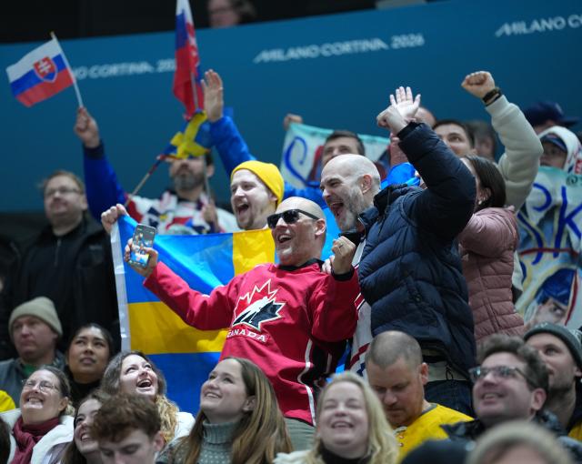 (260215) -- MILAN, Feb. 15, 2026 (Xinhua) -- Fans cheer during the ice hockey men's preliminary round group B match between Sweden and Slovakia of the Milan-Cortina 2026 Olympic Winter Games in Milan, Italy, Feb. 14, 2026. (Xinhua/Tao Xiyi)