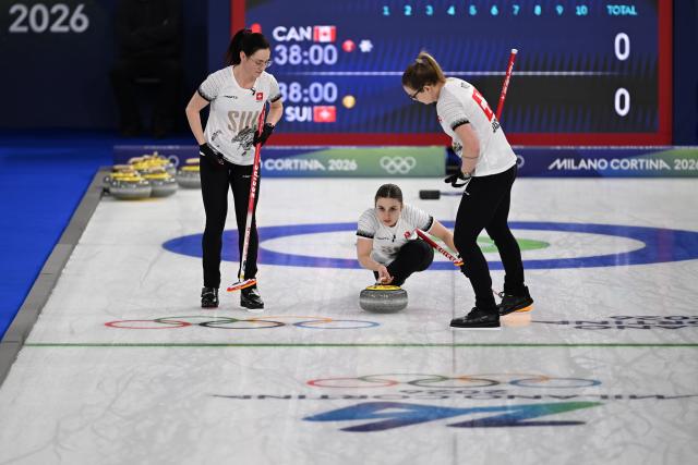 (260215) -- CORTINA D'AMPEZZO, Feb. 15, 2026 (Xinhua) -- Selina Witschonke (C) of Switzerland competes during the curling women round robin session 5 match between Switzerland and Canada at the 2026 Milan-Cortina Winter Olympics in Cortina, Italy, Feb. 14, 2026. (Xinhua/Lian Yi)