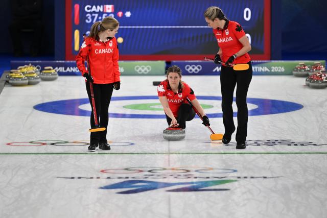(260215) -- CORTINA D'AMPEZZO, Feb. 15, 2026 (Xinhua) -- Sarah Wilkes (C) of Canada competes during the curling women round robin session 5 match between Switzerland and Canada at the 2026 Milan-Cortina Winter Olympics in Cortina, Italy, Feb. 14, 2026. (Xinhua/Lian Yi)