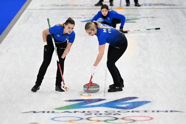 (260215) -- CORTINA D'AMPEZZO, Feb. 15, 2026 (Xinhua) -- Giulia Zardini Lacedelli (L) and Elena Mathis (R) of Italy compete during the curling women round robin session 5 match between Sweden and Italy at the 2026 Milan-Cortina Winter Olympics in Cortina, Italy, Feb. 14, 2026. (Xinhua/Lian Yi)