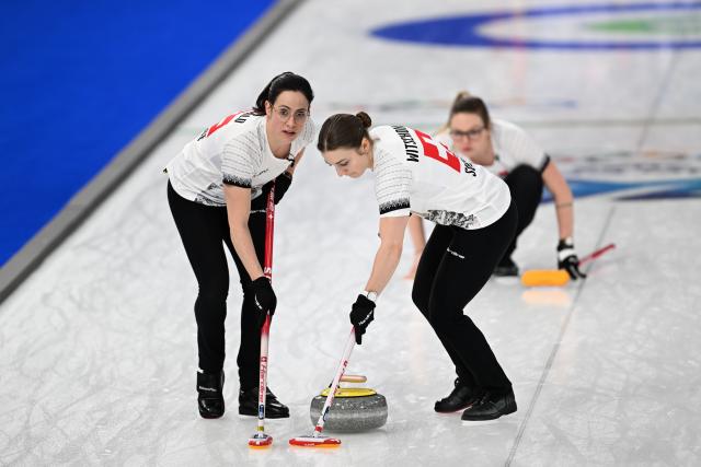 (260215) -- CORTINA D'AMPEZZO, Feb. 15, 2026 (Xinhua) -- Carole Howald (L) and Selina Witschonke of Switzerland compete during the curling women round robin session 5 match between Switzerland and Canada at the 2026 Milan-Cortina Winter Olympics in Cortina, Italy, Feb. 14, 2026. (Xinhua/Lian Yi)