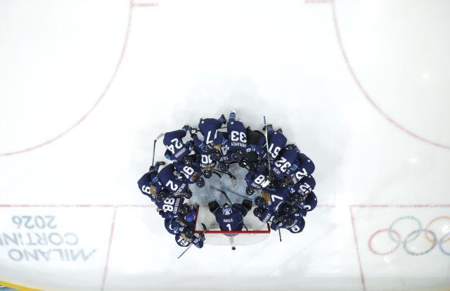 (260215) -- MILAN, Feb. 15, 2026 (Xinhua) -- Players of Finland cheer up before the ice hockey women's play-offs quarterfinal between Finland and Switzerland at the Milan-Cortina 2026 Olympic Winter Games in Milan, Italy, Feb. 14, 2026. (Xinhua/Wang Kaiyan)