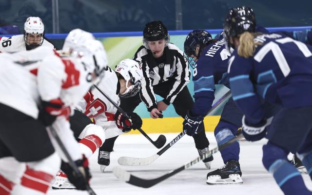 (260215) -- MILAN, Feb. 15, 2026 (Xinhua) -- Players compete during the ice hockey women's play-offs quarterfinal between Finland and Switzerland at the Milan-Cortina 2026 Olympic Winter Games in Milan, Italy, Feb. 14, 2026. (Xinhua/Wang Kaiyan)