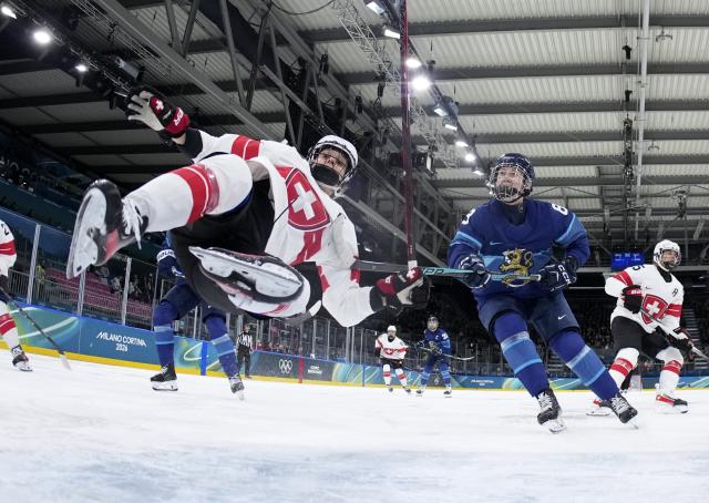 (260215) -- MILAN, Feb. 15, 2026 (Xinhua) -- Lara Stalder (L) of Switzerland competes during the ice hockey women's play-offs quarterfinal between Finland and Switzerland at the Milan-Cortina 2026 Olympic Winter Games in Milan, Italy, Feb. 14, 2026. (Xinhua/Wang Kaiyan)