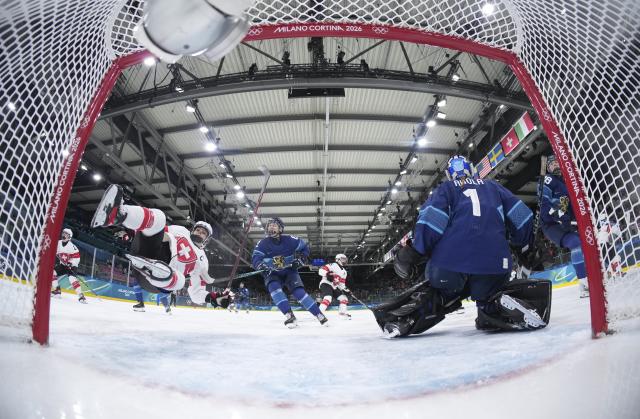 (260215) -- MILAN, Feb. 15, 2026 (Xinhua) -- Lara Stalder (2nd L) of Switzerland competes during the ice hockey women's play-offs quarterfinal between Finland and Switzerland at the Milan-Cortina 2026 Olympic Winter Games in Milan, Italy, Feb. 14, 2026. (Xinhua/Wang Kaiyan)