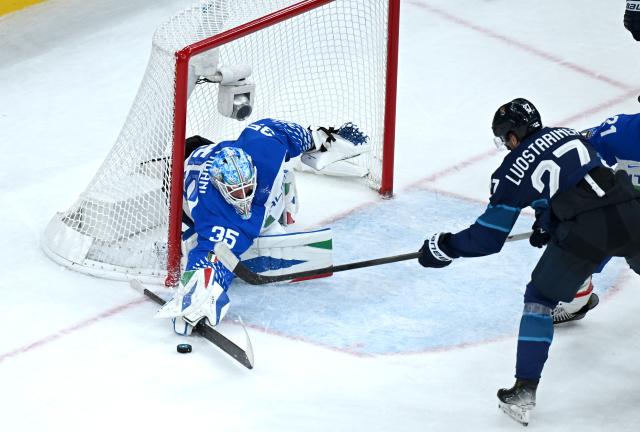 (260215) -- MILAN, Feb. 15, 2026 (Xinhua) -- Davide Fadani (L), goalkeeper of Italy, makes a save during the ice hockey men's preliminary round group B match between Italy and Finland of the Milan-Cortina 2026 Olympic Winter Games in Milan, Italy, Feb. 14, 2026. (Xinhua/Zhang Haofu)