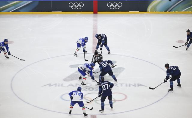 (260215) -- MILAN, Feb. 15, 2026 (Xinhua) -- Players compete during the ice hockey men's preliminary round group B match between Italy and Finland of the Milan-Cortina 2026 Olympic Winter Games in Milan, Italy, Feb. 14, 2026. (Xinhua/Zhang Haofu)