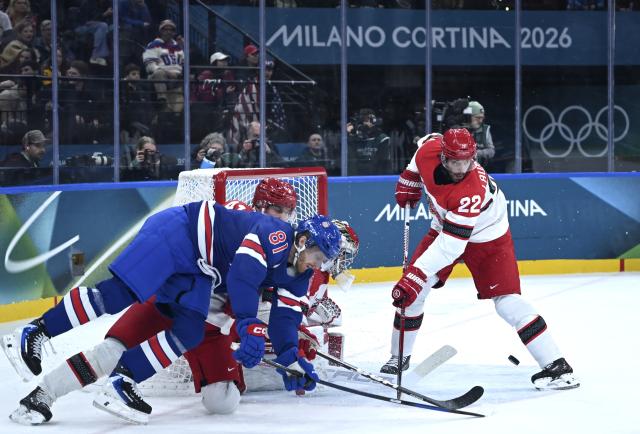 (260215) -- MILAN, Feb. 15, 2026 (Xinhua) -- Markus Lauridsen (R) of Denmark and Kyle Connor (L, front) of the United States comepte during the ice hockey men's preliminary round group C match between the United States and Denmark of the Milan-Cortina 2026 Olympic Winter Games in Milan, Italy, Feb. 14, 2026. (Xinhua/Zhang Haofu)