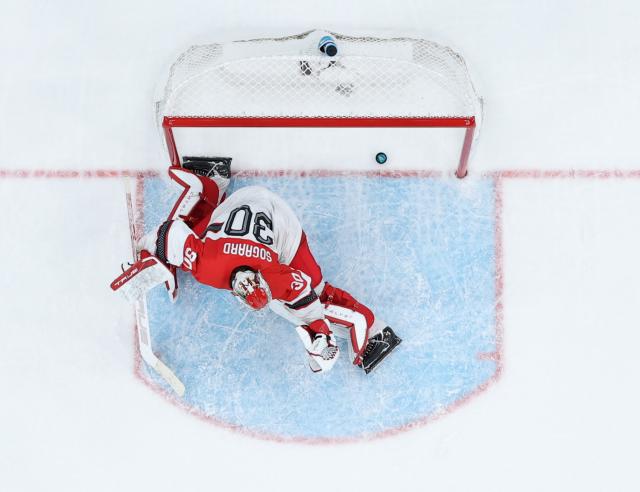 (260215) -- MILAN, Feb. 15, 2026 (Xinhua) -- Mads Sogaard, goalkeeper of Denmark, fails to make a save during the ice hockey men's preliminary round group C match between the United States and Denmark of the Milan-Cortina 2026 Olympic Winter Games in Milan, Italy, Feb. 14, 2026. (Xinhua/Zhang Haofu)