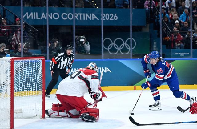 (260215) -- MILAN, Feb. 15, 2026 (Xinhua) -- Jack Hughes (R) of the United States competes during the ice hockey men's preliminary round group C match between the United States and Denmark of the Milan-Cortina 2026 Olympic Winter Games in Milan, Italy, Feb. 14, 2026. (Xinhua/Zhang Haofu)