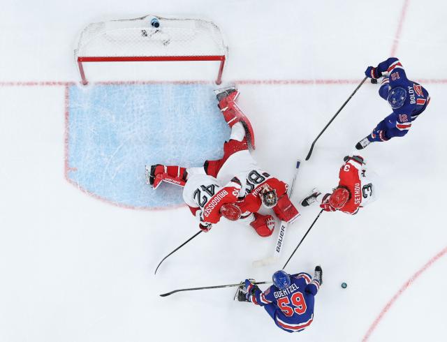 (260215) -- MILAN, Feb. 15, 2026 (Xinhua) -- Players compete during the ice hockey men's preliminary round group C match between the United States and Denmark of the Milan-Cortina 2026 Olympic Winter Games in Milan, Italy, Feb. 14, 2026. (Xinhua/Zhang Haofu)