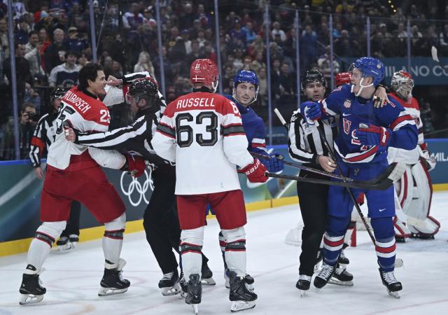 (260215) -- MILAN, Feb. 15, 2026 (Xinhua) -- Players clash during the ice hockey men's preliminary round group C match between the United States and Denmark of the Milan-Cortina 2026 Olympic Winter Games in Milan, Italy, Feb. 14, 2026. (Xinhua/Zhang Haofu)