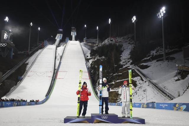 (260215) -- PREDAZZO, Feb. 15, 2026 (Xinhua) -- Gold medalist Domen Prevc (C) of Slovenia, silver medalist Nikaido Ren (L) of Japan and bronze medalist Kacper Tomasiak of Poland pose during the awarding ceremony for the ski jumping men's large hill individual event at the Milan-Cortina 2026 Olympic Winter Games in Predazzo, Italy, Feb. 14, 2026. (Xinhua/Huang Wei)