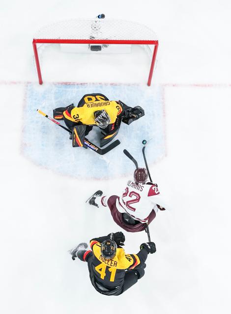 (260215) -- MILAN, Feb. 15, 2026 (Xinhua) -- Sandis Vilmanis (C) of Latvia competes during the ice hockey men's preliminary round group C match between Germany and Latvia of the Milan-Cortina 2026 Olympic Winter Games in Milan, Italy, Feb. 14, 2026. (Xinhua/Sun Fei)