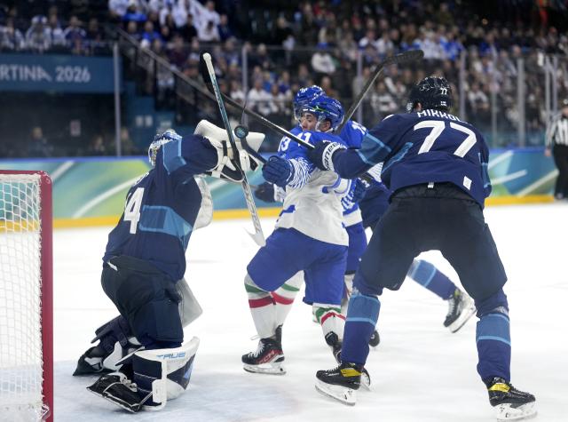 (260215) -- MILAN, Feb. 15, 2026 (Xinhua) -- Marco Zanetti (C) of Italy vies with Juuse Saros (L), goalkeeper of Finland, during the ice hockey men's preliminary round group B match between Italy and Finland of the Milan-Cortina 2026 Olympic Winter Games in Milan, Italy, Feb. 14, 2026. (Xinhua/Tao Xiyi)