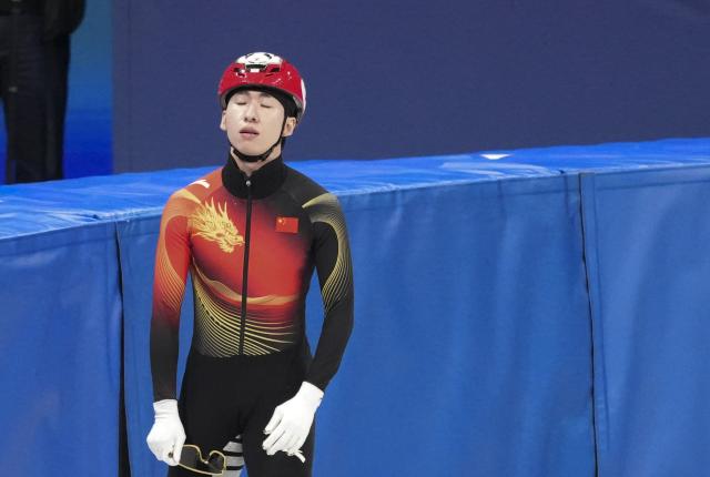 (260215) -- MILAN, Feb. 15, 2026 (Xinhua) -- Lin Xiaojun of China reacts after falling on ice during the short track speed skating men's 1500m quarterfinal 4 at the Milan-Cortina 2026 Olympic Winter Games in Milan, Italy, Feb. 14, 2026. (Xinhua/Xue Yuge)