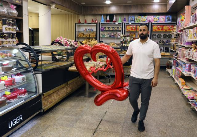 (260215) -- BAGHDAD, Feb. 15, 2026 (Xinhua) -- A man buys Valentine's Day gift at a store in Baghdad, Iraq, on Feb. 14, 2026. (Xinhua/Khalil Dawood)