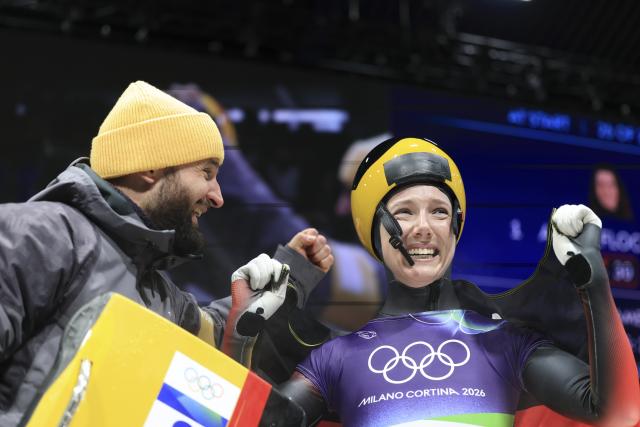 (260215) -- CORTINA D'AMPEZZO, Feb. 15, 2026 (Xinhua) -- Susanne Kreher (R) of Germany reacts during the skeleton women's heat at the Milan-Cortina 2026 Olympic Winter Games in Cortina, Italy, Feb. 14, 2026. (Xinhua/Ding Xu)